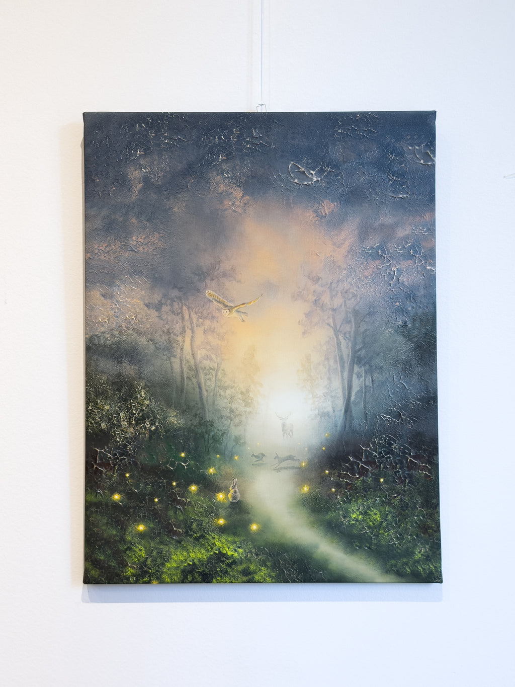 Forest themed canvas print hanging on the wall.