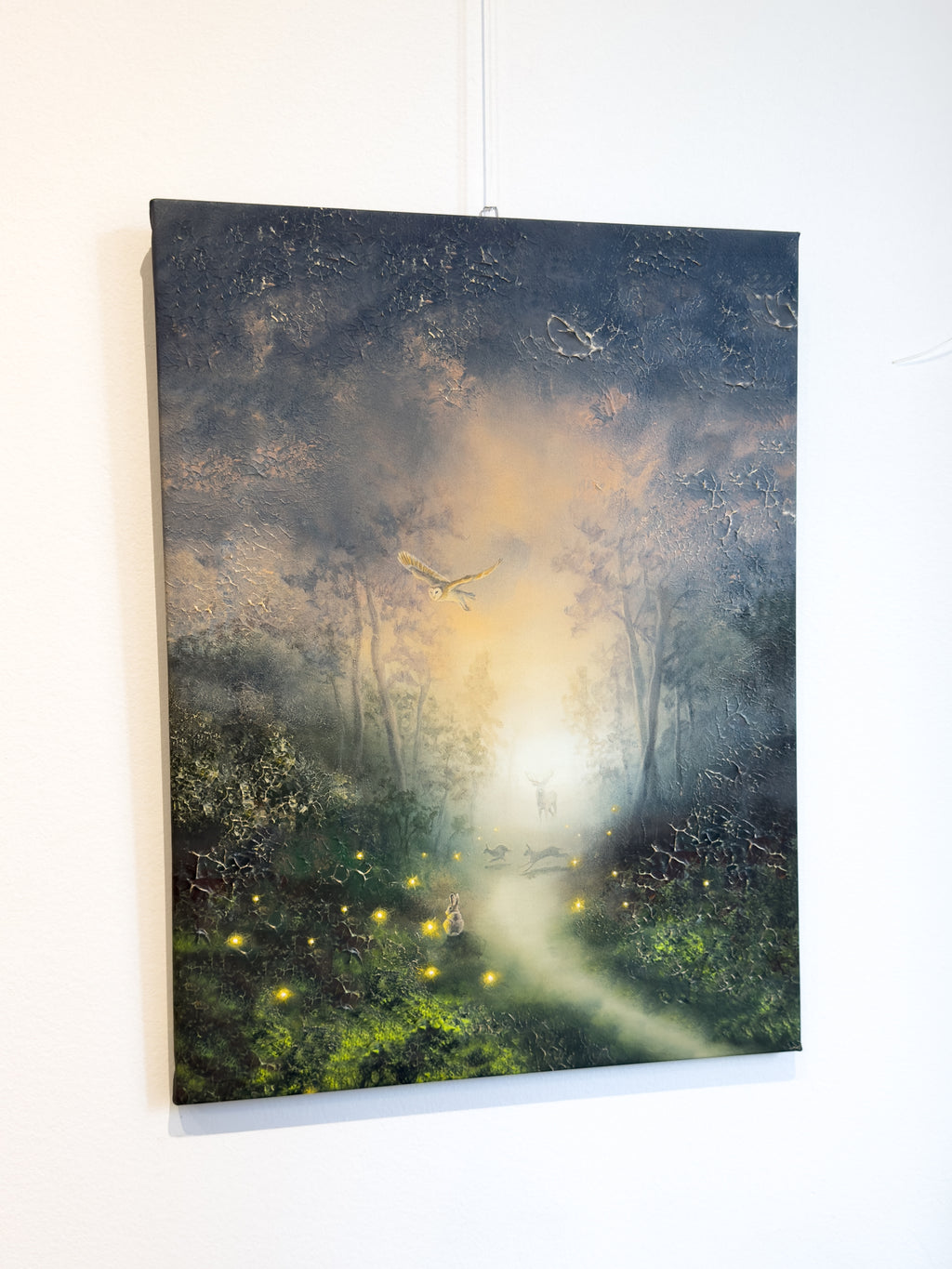 Side picture of forest themed canvas print hanging on the wall.