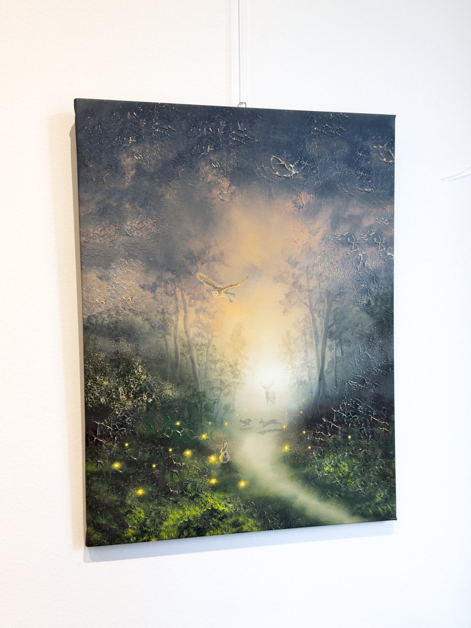 Side picture of forest themed canvas print hanging on the wall.