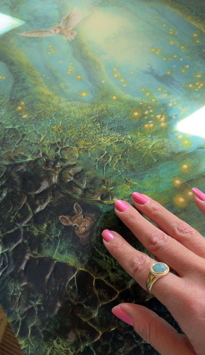 Details of the print of the semi-abstract landscape of a mystical mossy forest featuring a deer, a rabbit, a flying owl and glowing fireflies.