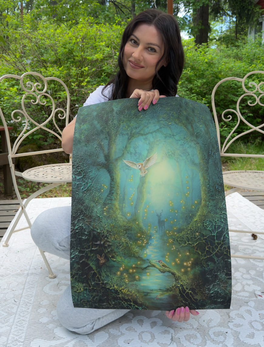 Jenni Inberg smiling at the camera while holding a fine art print of the mossy forest.