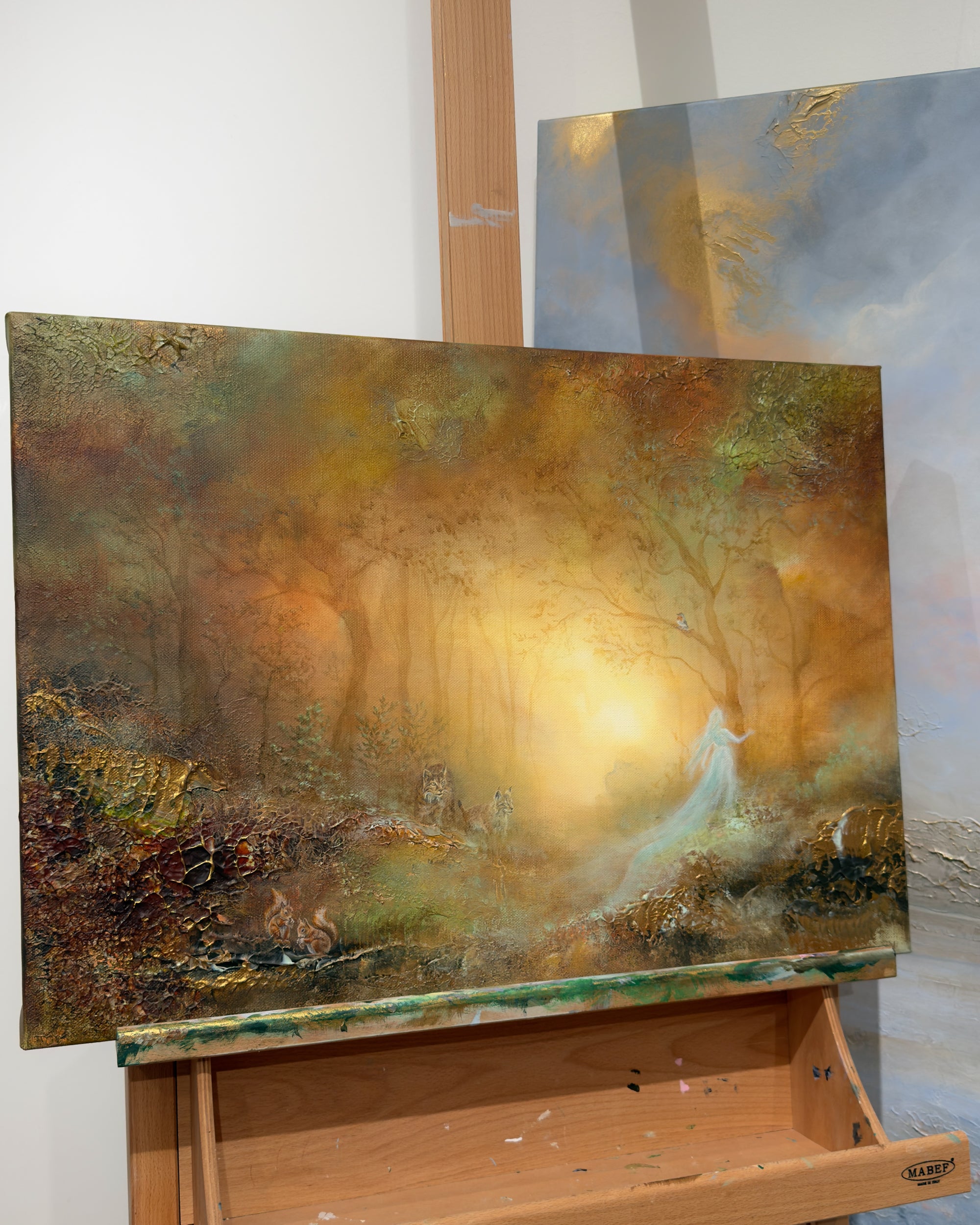 Side view of the original lynx painting displayed on an easel.