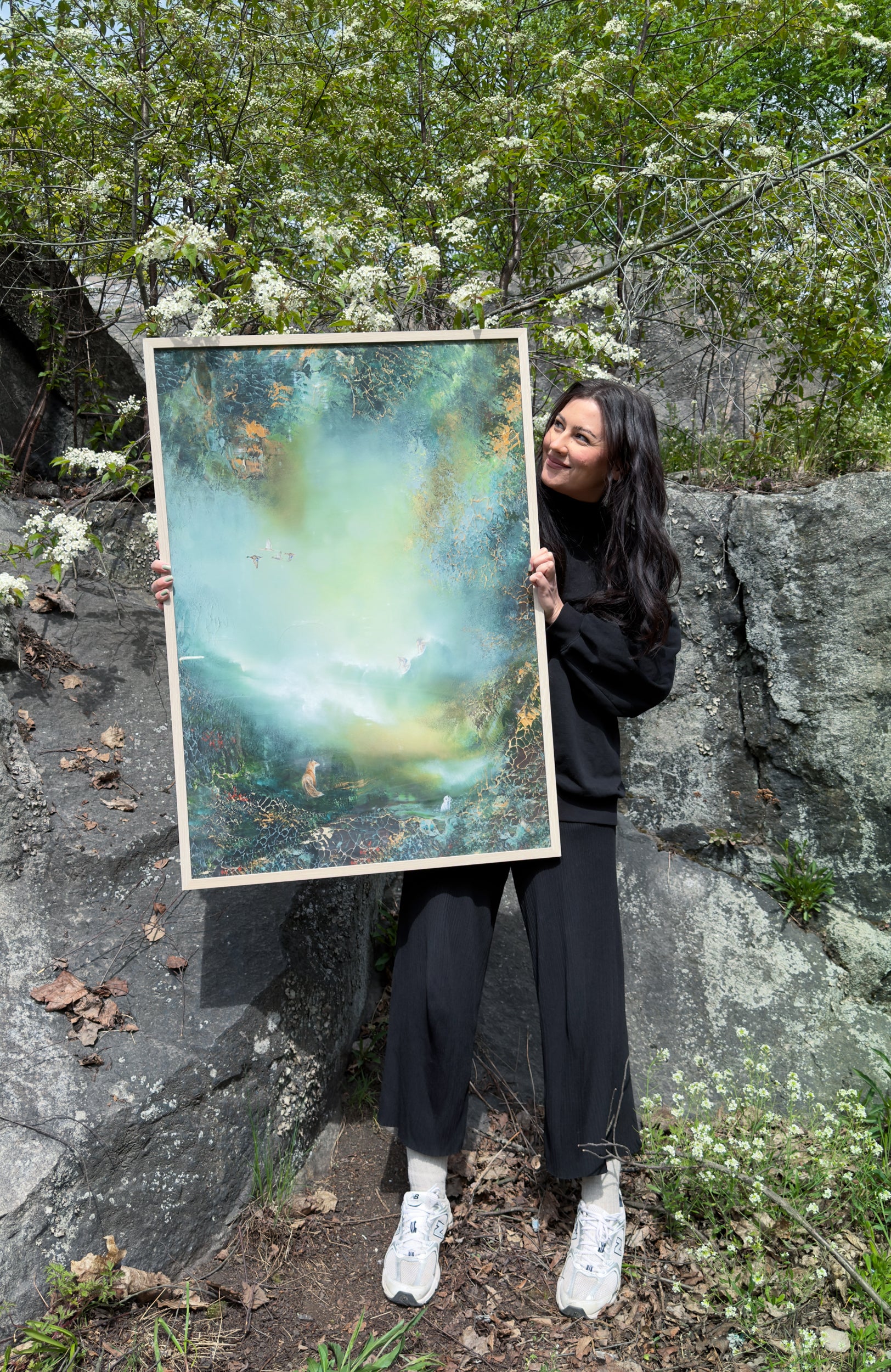 Jenni Inberg holding the framed fine art print to demonstrate its size.