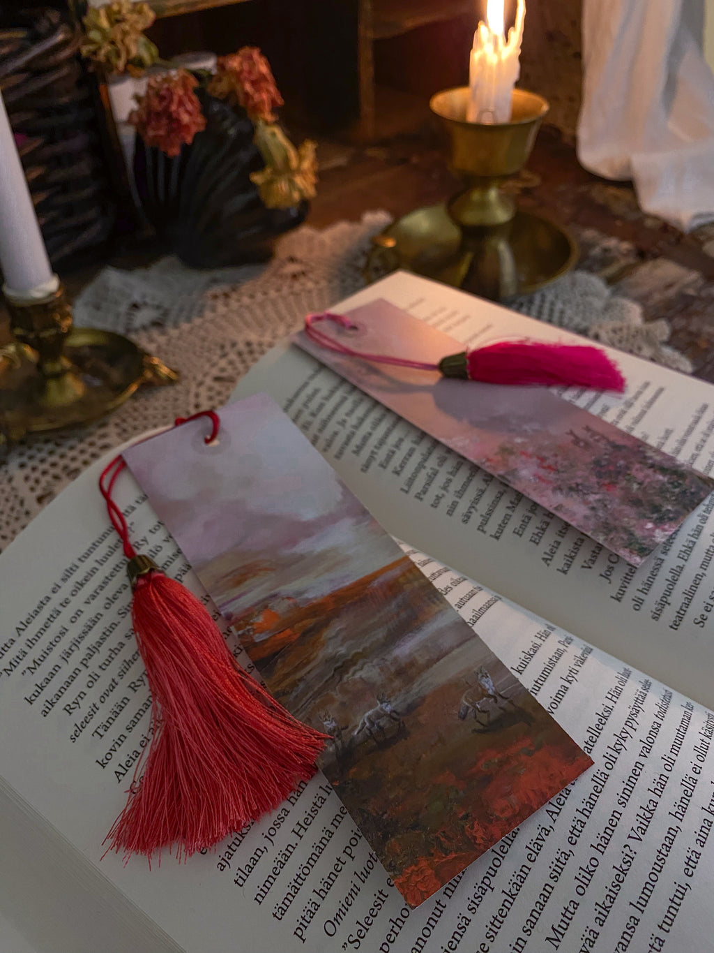 Fantasy-inspired art bookmarks displayed together in a cozy reading setting.