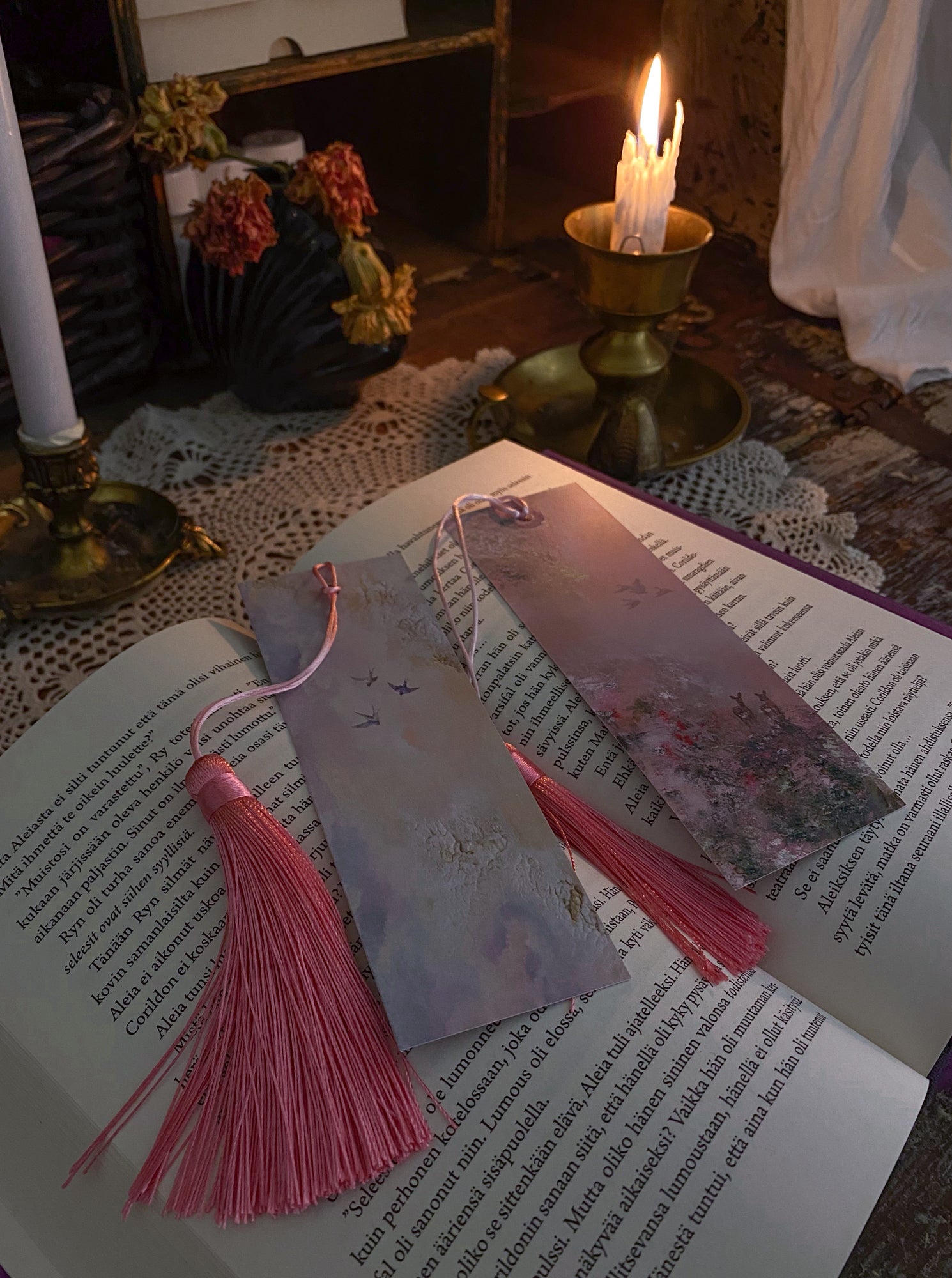 Fantasy-inspired art bookmarks displayed together in a cozy reading setting.