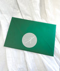 Green mystery envelope containing a surprise A5 fine art print.