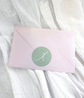 Pink mystery envelope containing a surprise A5 fine art print and bookmark.